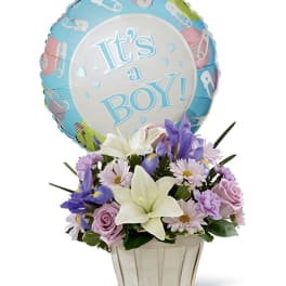 Flower basket with a "It's a Boy!" balloon and pastel blooms