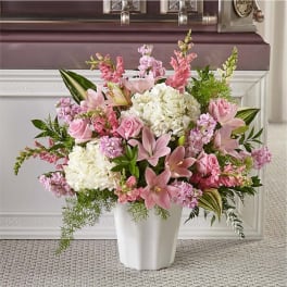 Pink and white floral arrangement in a white vase