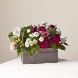 Mixed pink and white flower arrangement in a rectangular box