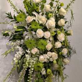 Tall white and green floral spray on an easel