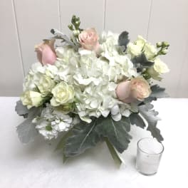 White hydrangea and pale pink rose bouquet with gray foliage