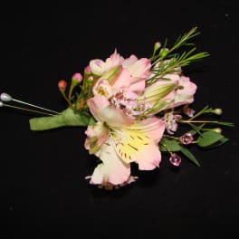 Pink and white floral boutonniere with decorative pins
