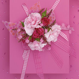 Pink bouquet with carnations and roses on a pink background