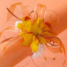 Yellow orchid corsage with orange ribbon and decorative wire loops