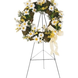 Daisy wreath on a standing easel with a cream ribbon