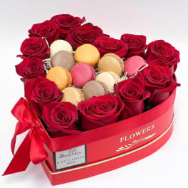 Heart-shaped box of red roses with assorted macarons