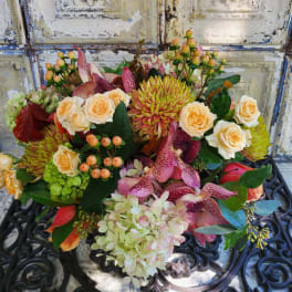 Mixed bouquet with peach roses, pink orchids, and green chrysanthemums