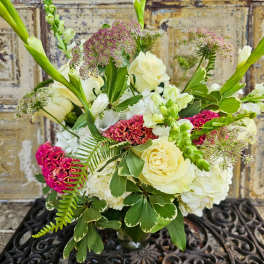 Bouquet of cream roses and white blooms with pink accents