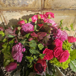 Bouquet of pink roses and purple chrysanthemums with mixed greenery