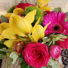 Bouquet of yellow calla lilies, pink gerbera daisies, and roses