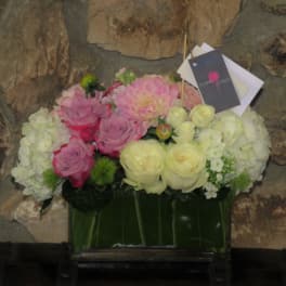 Pink and white flower arrangement in a glass vase