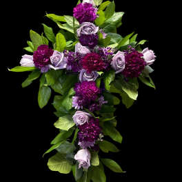 Purple roses and carnations arranged in a cross shape