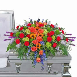 Colorful floral casket spray with roses and mixed blooms