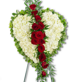 Heart-shaped standing arrangement of white flowers with a cascade of red roses.