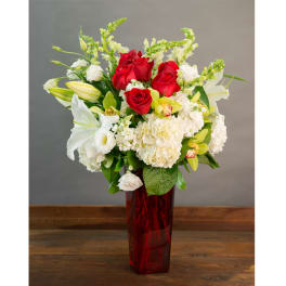 Red roses and white lilies in a tall red vase