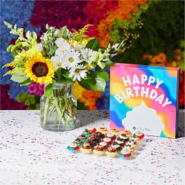 Birthday gift set with sunflower and daisy bouquet, dessert tray, and colorful Happy Birthday box