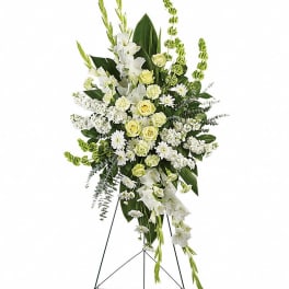 Tall white and pale yellow floral standing spray on an easel