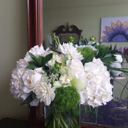 White floral arrangement in a clear glass vase