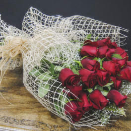 Bouquet of red roses wrapped in white mesh