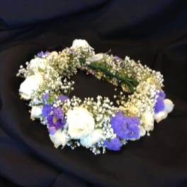 White and purple floral wreath on a black background