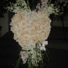 Large white floral standing spray with roses and orchids