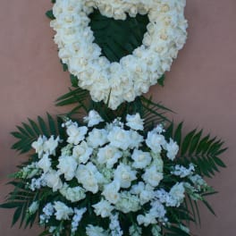 White floral funeral wreath with a matching spray below