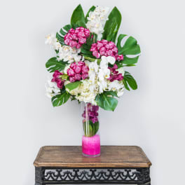 Tall vase arrangement with pink roses and white orchids