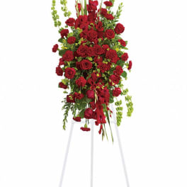 Tall red floral standing spray on a white easel