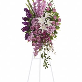 Tall purple and white floral standing spray on an easel