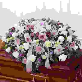 Large black-and-white floral arrangement with pink accents in a vase