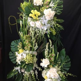 Tall floral standing arrangement with white and pale yellow blooms