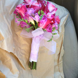 Pink and lavender bouquet wrapped with a pale ribbon
