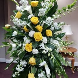 Tall yellow and white floral standing spray on an easel