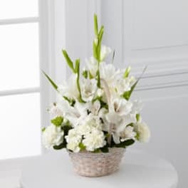 White floral arrangement in a woven basket