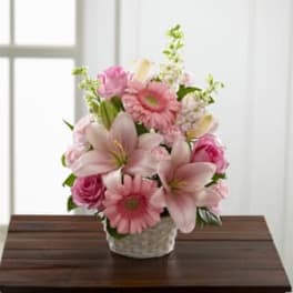 Pink bouquet with lilies, gerbera daisies, and roses in a white vase