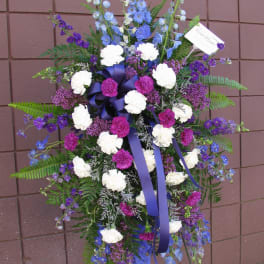 Tall standing floral spray with purple, blue, and white flowers