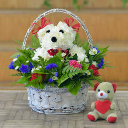 Basket arrangement with a teddy bear and white flower bear design