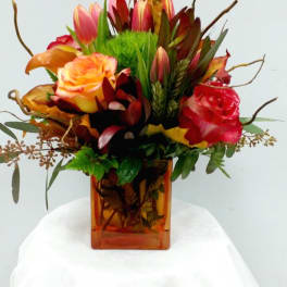 Mixed bouquet of roses and tulips in an amber glass vase