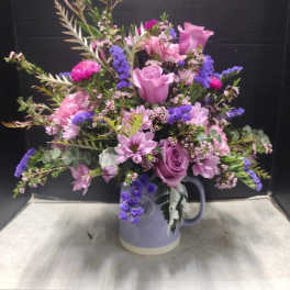 Lavender and pink mixed bouquet in a ceramic pitcher vase