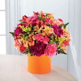 Bright mixed bouquet in an orange box.