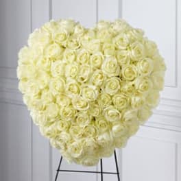 Heart-shaped arrangement of pale yellow roses on a stand