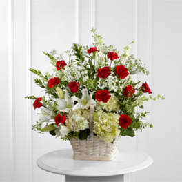 Basket arrangement of red roses and white lilies