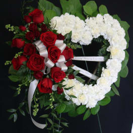 Heart-shaped floral wreath with red roses and white carnations