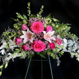 Pink roses and white lilies in a wide floral arrangement