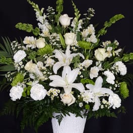 White floral arrangement in a textured white vase