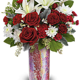 Red roses and white lilies in a colorful mosaic vase