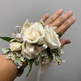 White rose wrist corsage with ribbon and small filler flowers