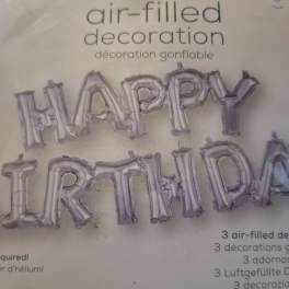 Silver birthday letter balloons spelling Happy Birthday