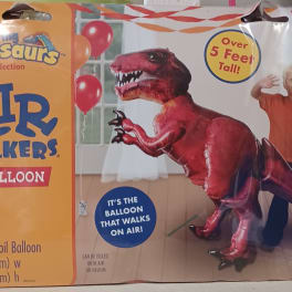Package for a red dinosaur foil balloon with a child pictured beside it.