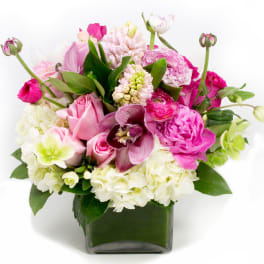 Pink and white mixed bouquet in a square glass vase
